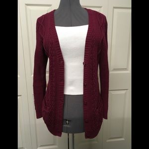 Burgundy cardigan sweater.
